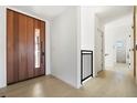 Bright entryway with light wood floors, a solid wood door, and minimalist black accents, creating a modern welcome at 2206 Alpine Dr, Boulder, CO 80304