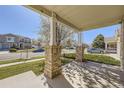 Inviting front porch with brick columns, offering a view of the neighborhood street at 5131 Netherland St, Denver, CO 80249