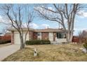 Brick ranch home with attached garage and front yard at 4611 S Queen St, Littleton, CO 80127