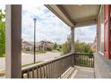 Inviting front porch offers serene neighborhood views, great for relaxing outdoors and enjoying the community at 9643 Birch Ln, Thornton, CO 80229