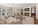 Spacious living room with a cozy fireplace, stylish furniture, and seamless access to the outdoor area at 344 Saint Paul St, Denver, CO 80206