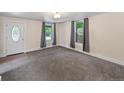 Bright living room featuring neutral walls, gray carpet, and ample natural light from the windows at 4232 S Grant St, Englewood, CO 80113