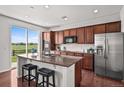 Spacious kitchen island featuring granite countertops and stainless appliances, offering a modern space at 15602 E 117Th Ave, Commerce City, CO 80022
