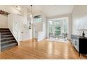 Bright, open living room with hardwood floors, large windows and staircase at 1412 Pinyon Dr, Castle Rock, CO 80104