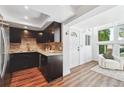 Dark wood kitchen with stainless steel appliances and granite countertops at 8387 S Reed St # B3, Littleton, CO 80128