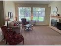 Cozy living room with large windows, fireplace, and comfortable seating at 9798 Grove St, Westminster, CO 80031