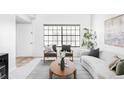 Cozy living area with a large window, comfortable seating, and contemporary decor at 8787 Yukon St, Arvada, CO 80005