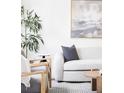 Living room boasts modern décor, including a comfortable sofa and stylish accent chairs at 8787 Yukon St, Arvada, CO 80005