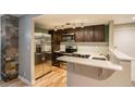 Modern kitchen with stainless steel appliances and dark wood cabinets at 830 N Sherman St # 106, Denver, CO 80203