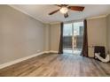 Living room with hardwood floors and sliding glass door to patio at 830 N Sherman St # 106, Denver, CO 80203