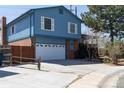 Charming blue two-story home featuring a brick facade and a two car garage on a sunny day at 6720 W 112Th Pl, Westminster, CO 80020
