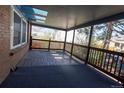 The spacious covered porch features a wood deck and railing offering views of the neighborhood at 6720 W 112Th Pl, Westminster, CO 80020