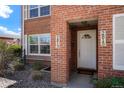 Close-up of the brick townhouse entryway, showing address numbers and a welcoming doorway at 2813 Jasmine St, Denver, CO 80207