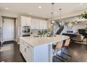 Bright kitchen with a large island, modern appliances, and open layout connecting to the living area at 11096 Endeavor Dr, Parker, CO 80134