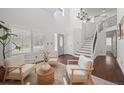 Bright living room featuring high ceilings, modern furniture, and natural light at 8783 S Carr Way, Littleton, CO 80128