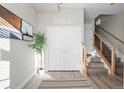 Welcoming foyer with staircase, modern decor, and wood flooring at 2620 S Delaware St # 3, Denver, CO 80223