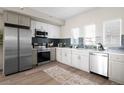 Modern kitchen with stainless steel appliances, white cabinets, and a stylish backsplash at 2620 S Delaware St # 3, Denver, CO 80223