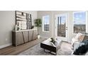 Cozy living room with modern decor, a stylish cabinet, and a view to a balcony at 2620 S Delaware St # 3, Denver, CO 80223