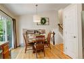 Cozy dining room featuring hardwood floors, a round table, and elegant decor at 12671 Meadow Bridge Way, Parker, CO 80134