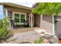 Inviting front porch with stone accents, rocking chairs, and decorative plants at 12671 Meadow Bridge Way, Parker, CO 80134