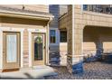 Close up of an entrance featuring two doors with stone veneer and a wreath at 11250 Florence St # 22B, Commerce City, CO 80640