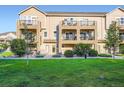Beautiful exterior view of a townhome featuring multiple balconies and lush green landscaping at 11250 Florence St # 22B, Commerce City, CO 80640