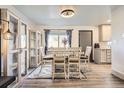 Bright dining room features stylish furnishings, natural light, and seamless flow to the kitchen and living spaces at 1002 S Miller St, Lakewood, CO 80226