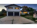 A charming home with a well-maintained driveway and lawn at 5611 W Bates Ave, Denver, CO 80227