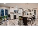 A bright kitchen featuring an island with barstool seating at 5611 W Bates Ave, Denver, CO 80227