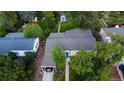 Aerial view of the home featuring a lush backyard with mature trees and a convenient carport at 3018 S Cherry Way, Denver, CO 80222