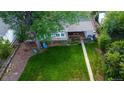Expansive backyard featuring a well-maintained lawn, mature trees, and a cozy deck area at 3018 S Cherry Way, Denver, CO 80222