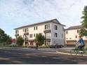 Modern two-story townhouses with people and cyclist nearby at 6643 W 52Nd Ave # C, Arvada, CO 80002