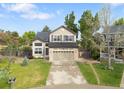 Well-maintained two-story home with a neatly manicured lawn and an extended driveway at 9898 Tourmaline Ct, Parker, CO 80134
