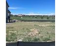 Picture of an expansive backyard with lush grass and a view of the surrounding neighborhood at 14513 Hudson Way, Thornton, CO 80602