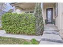 Inviting covered front porch with string lights and lush green shrubbery at 19 S 45Th Ave, Brighton, CO 80601