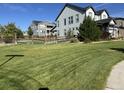 Large, well-maintained back yard with wooden fence and lush green lawn at 8739 Culebra St, Arvada, CO 80007