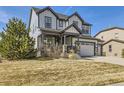 Beautiful two-story house features stylish siding, complemented by a well-maintained lawn and landscaping at 8739 Culebra St, Arvada, CO 80007