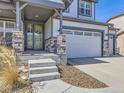 Welcoming home features a stylish front entry with a decorative glass door and a spacious two car garage at 8739 Culebra St, Arvada, CO 80007