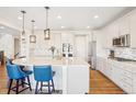 Beautiful kitchen featuring a large island with seating, stainless steel appliances, and hardwood floors at 5227 Lake Port Ave, Longmont, CO 80504