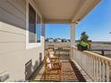 Inviting front porch features a cozy seating area, flower boxes and relaxing outdoor space at 5227 Lake Port Ave, Longmont, CO 80504