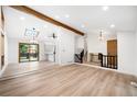 Bright living area with light wood floors, wood beam and access to the yard at 655 Cree Cir, Boulder, CO 80303