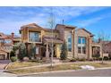 Charming two-story home featuring a mix of stucco, stone, and a striking roofline with a balcony at 9550 Firenze Way, Highlands Ranch, CO 80126