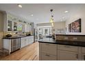 Modern kitchen featuring white cabinets, stainless appliances, and bar seating at 1572 Leyden St, Denver, CO 80220