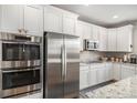 Well-equipped kitchen featuring stainless steel appliances and white cabinetry at 3378 Shoveler Trl, Castle Rock, CO 80104