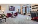 A bright living room with large windows, a fireplace, and comfortable seating at 748 Ridgeside Dr, Golden, CO 80401