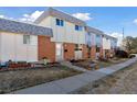 Charming townhome row featuring a mix of brick and siding, complemented by a well-kept lawn at 1009 Milky Way, Thornton, CO 80260