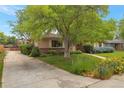 Charming single-story home with a well-manicured lawn and mature landscaping at 2309 E Floyd Pl, Englewood, CO 80113