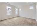 An airy room featuring neutral walls, carpet, recessed lighting, and three windows at 2188 S Haleyville Way, Aurora, CO 80018