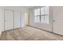 Bright bedroom with neutral carpet, ample natural light, and a closet with sliding doors at 2188 S Haleyville Way, Aurora, CO 80018