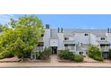 View of the building's exterior with lush green landscaping around the grounds at 3141 S Tamarac Dr # 111G, Denver, CO 80231
